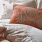 Brick color jacquard shams and white duvet cover decorated with bronze color embroideries