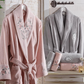 Bathroom designed with  powder-pink, cotton women`s robe and grey men`s robe 