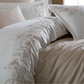Brick and grey color floral ornaments on duvet cover and shams pairs with beige bed sheet