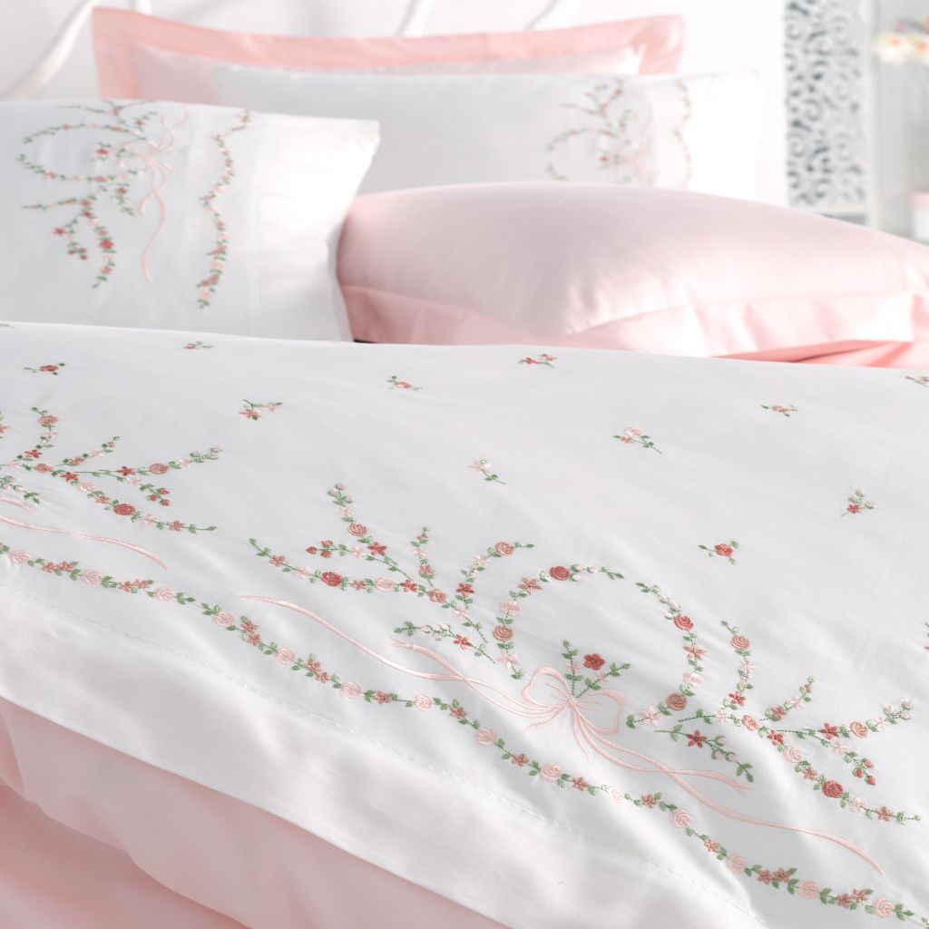 White duvet cover and shams decorated with delicate, pink and green floral embroideries