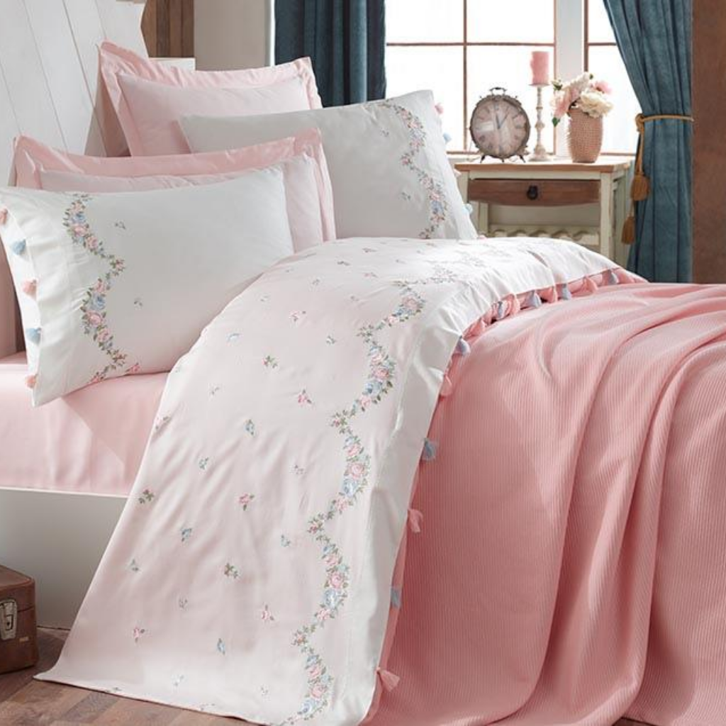 Romantic bedroom decorated with pink, cotton bed linen and blanket