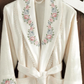 Women`s robe in classic kimono design with lace and floral patterns at the collar