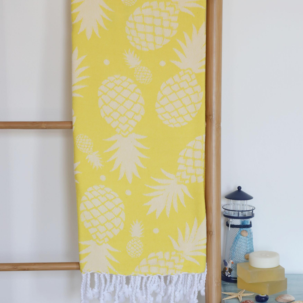 Bright yellow Turkish peshtemal beach towel has pineapple designs