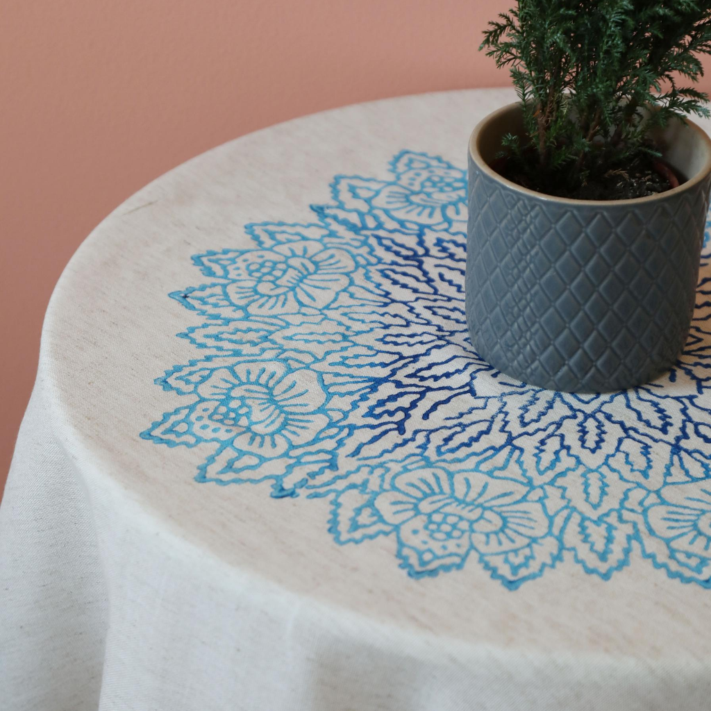 Floral designs in tones of blue on a linen table cloth